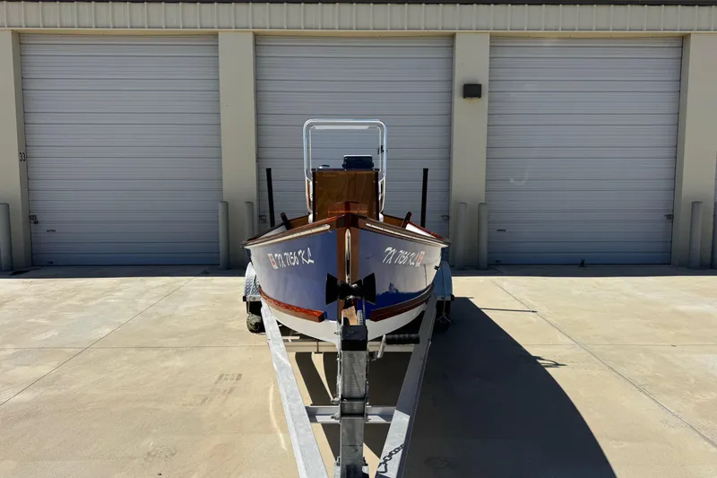 Slide: The Image of 2022 Farley Port A Skiff boat on trailer in front of storage units. - 2