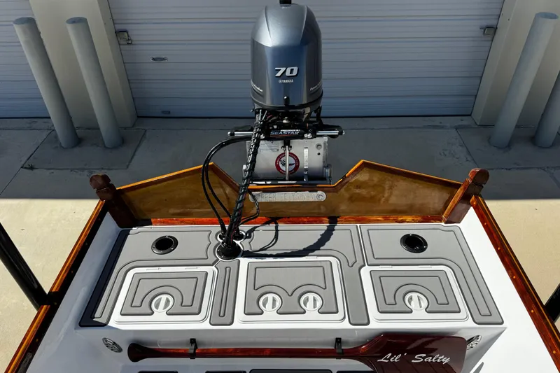 Slide: The Image of 2022 Farley Port A Skiff boat with Yamaha 70 engine, docked near a garage. - 29