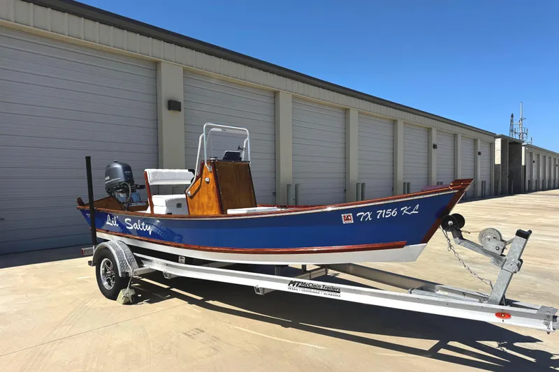 Slide: The Image of 2022 Farley Port A Skiff boat on trailer, parked outside storage facility. - 4