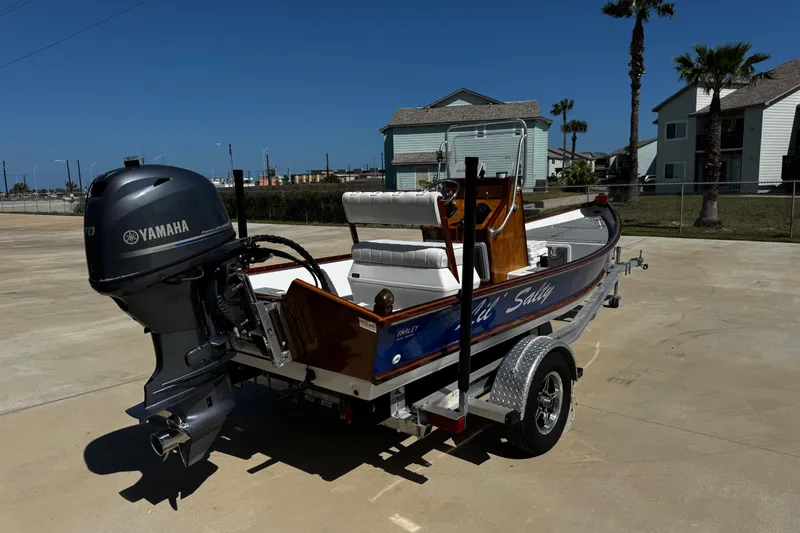 Slide: The Image of 2022 Farley Port A Skiff boat with Yamaha motor on trailer, parked outdoors. - 8