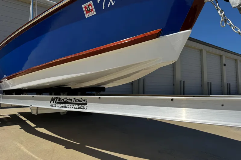 Slide: The Image of 2022 Farley Port A Skiff on McClain trailer, blue and white hull, outdoor storage. - 9