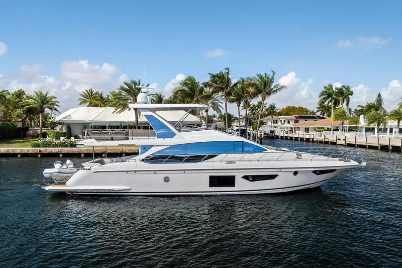 The Image of Luxury 2020 Azimut 66 yacht cruising near palm-lined waterfront homes. - 0