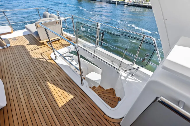 Slide: The Image of Luxurious 2020 Azimut 66 yacht deck with wooden flooring and elegant seating. - 10