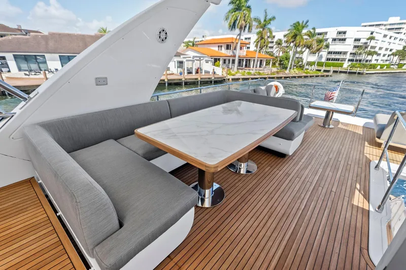 Slide: The Image of Luxurious 2020 Azimut 66 yacht deck with elegant seating and waterfront view. - 12