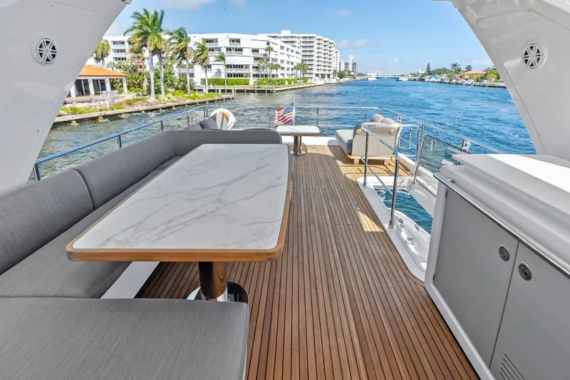 Slide: The Image of Luxurious 2020 Azimut 66 yacht deck with elegant seating and scenic waterfront view. - 13