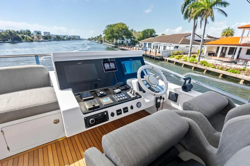 Slide: The Image of Helm of 2020 Azimut 66 yacht with modern controls, cruising on a scenic waterway. - 15