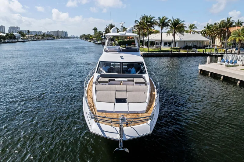 Slide: The Image of Luxurious 2020 Azimut 66 yacht cruising on a scenic waterway with palm trees. - 2