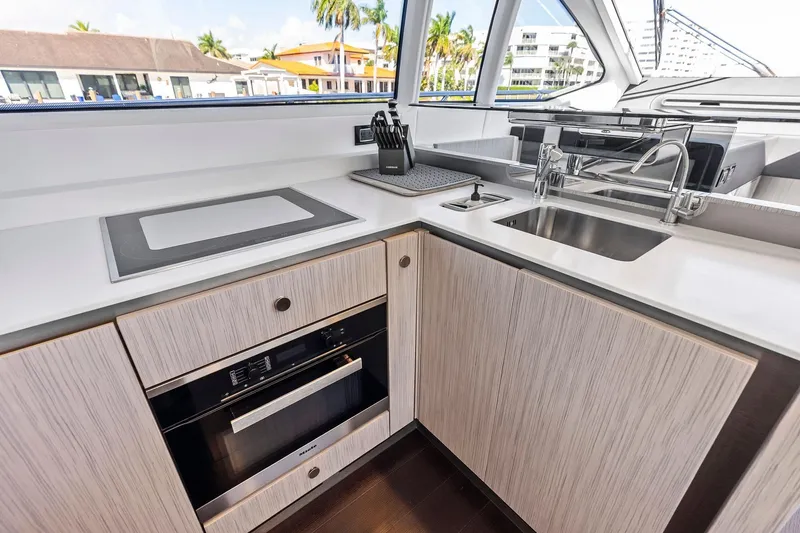 Slide: The Image of Modern kitchen interior on 2020 Azimut 66 yacht, featuring sleek countertops and appliances. - 23