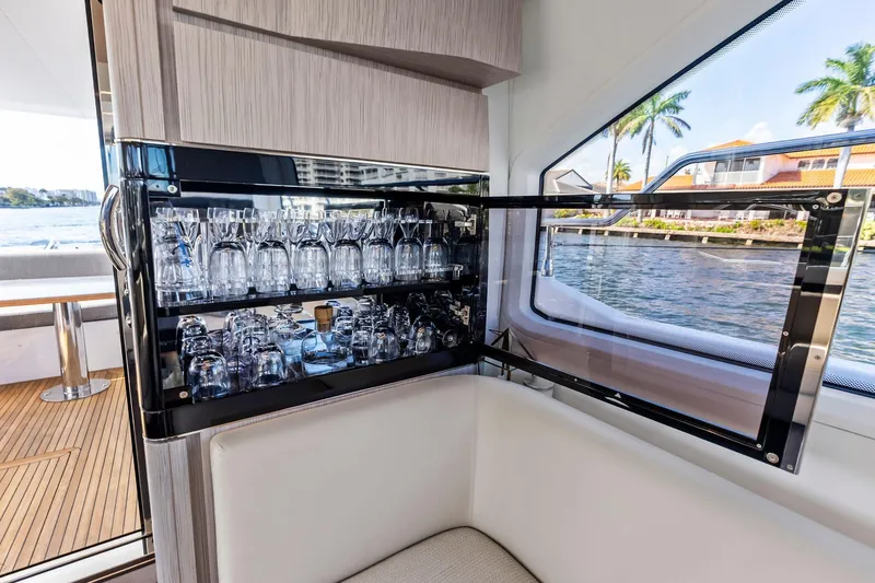 Slide: The Image of Luxurious interior of 2020 Azimut 66 yacht with glassware display and scenic water view. - 24