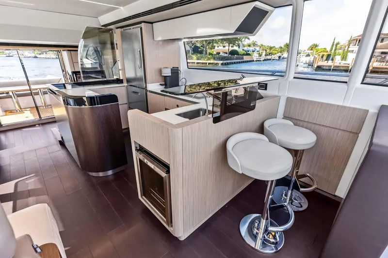Slide: The Image of Luxurious interior of 2020 Azimut 66 yacht with modern kitchen and bar stools. - 29