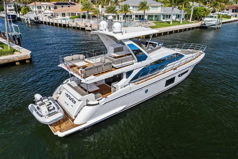 Slide: The Image of Luxurious 2020 Azimut 66 yacht cruising near waterfront homes. - 3