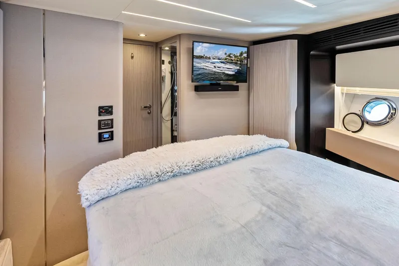 Slide: The Image of Luxurious bedroom interior of 2020 Azimut 66 yacht with TV and porthole window. - 36