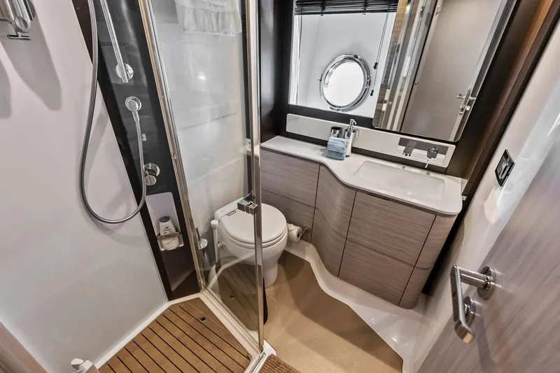 Slide: The Image of Luxurious bathroom interior of 2020 Azimut 66 yacht with modern fixtures and porthole window. - 37