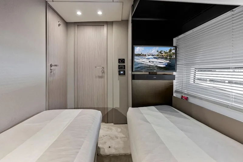Slide: The Image of Luxurious interior of 2020 Azimut 66 yacht with twin beds and a flat-screen TV. - 45