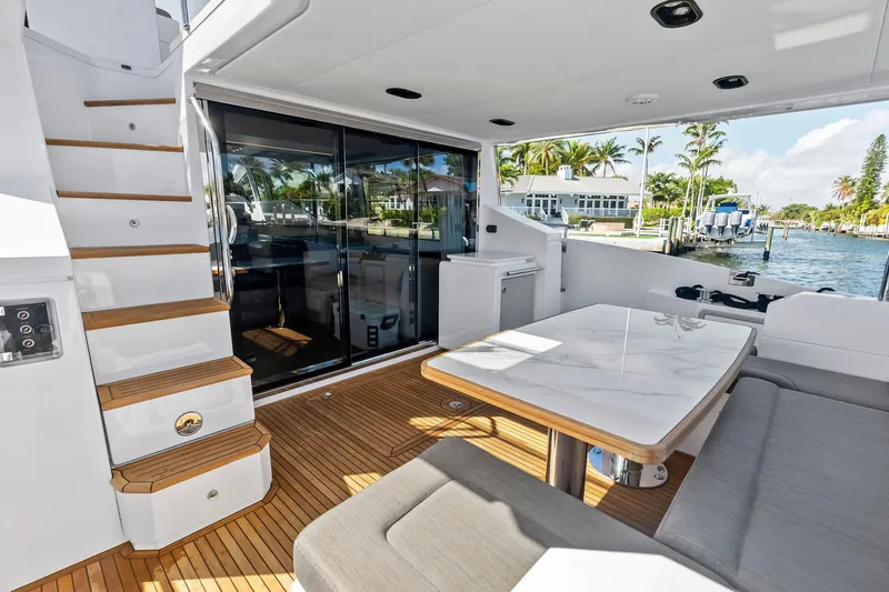 Slide: The Image of Luxurious 2020 Azimut 66 yacht deck with elegant seating and scenic waterfront view. - 5