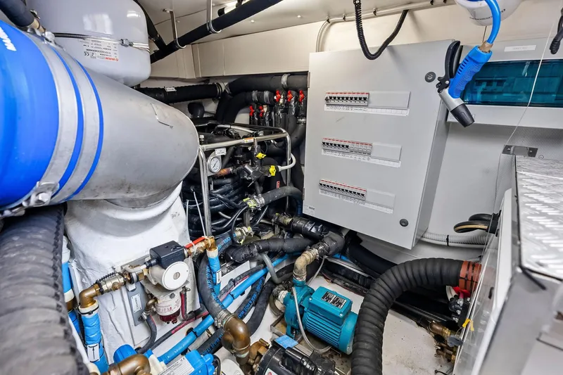 Slide: The Image of Engine room of a 2020 Azimut 66 yacht, showcasing complex machinery and control panels. - 51