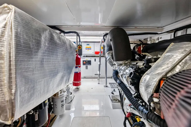 Slide: The Image of Engine room of a 2020 Azimut 66 yacht, featuring machinery and safety equipment. - 55