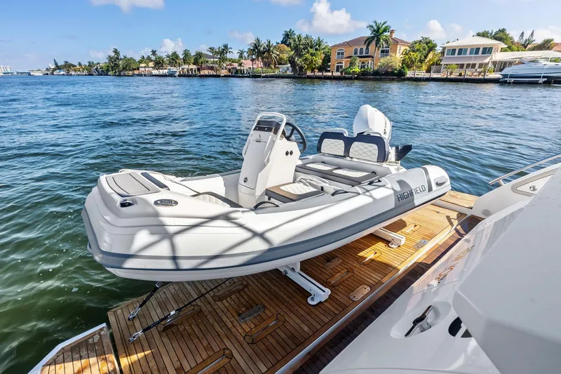 Slide: The Image of Luxury Azimut 66 yacht with tender on deck, 2020 model, docked by waterfront homes. - 7