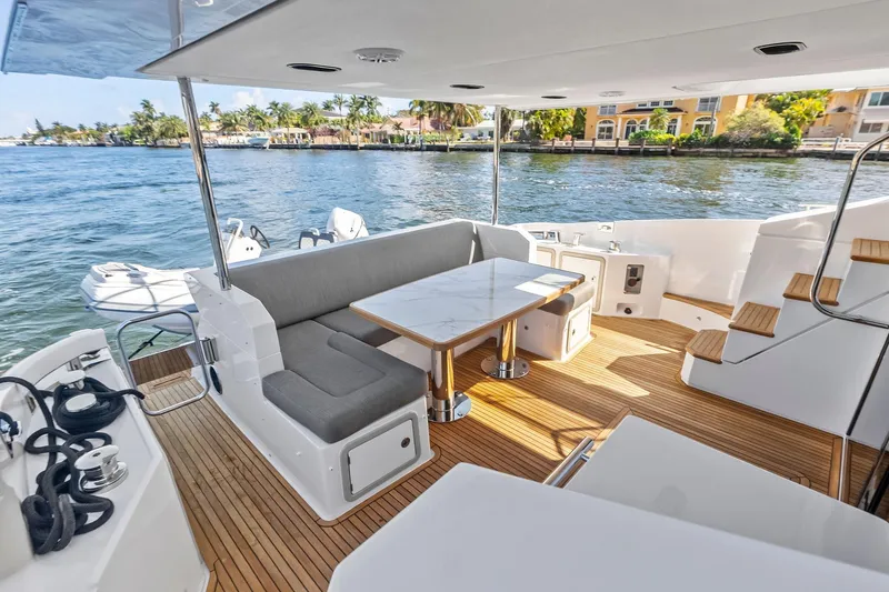 Slide: The Image of Luxurious 2020 Azimut 66 yacht deck with seating, table, and scenic waterfront view. - 8