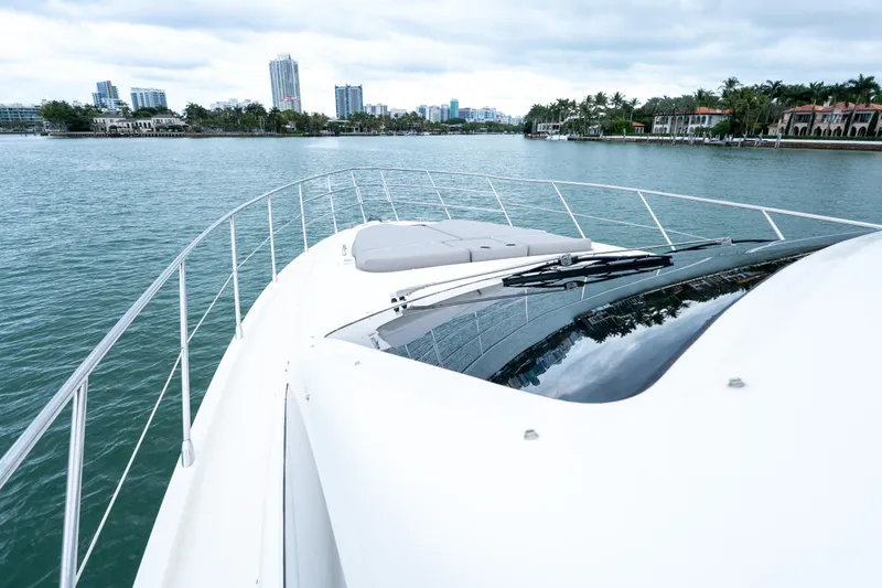 Slide: The Image of 2008 Azimut 62E yacht cruising near waterfront cityscape. - 11