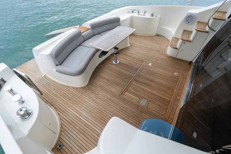 Slide: The Image of Luxurious 2008 Azimut 62E yacht deck with elegant seating and wooden flooring. - 14
