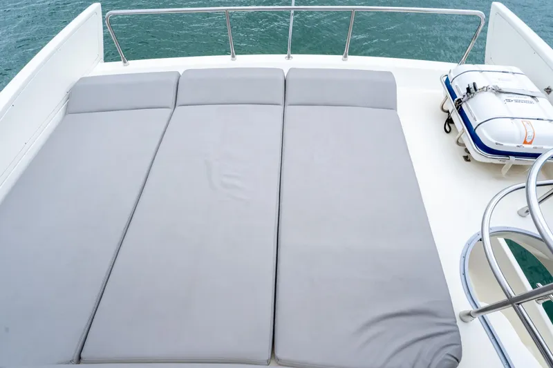 Slide: The Image of Sunbathing deck on 2008 Azimut 62E yacht with gray cushions and safety equipment. - 19