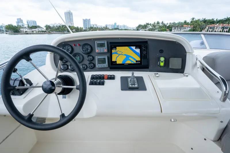 Slide: The Image of Helm of 2008 Azimut 62E yacht with navigation controls and city skyline view. - 22