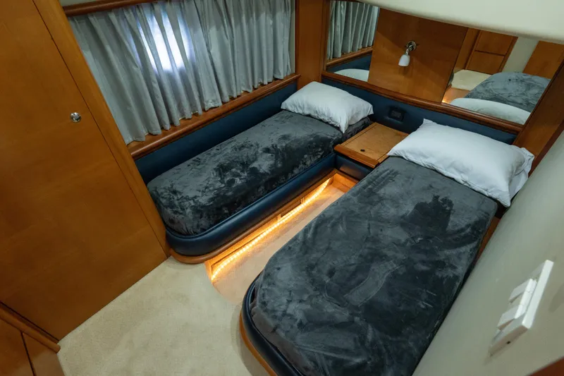 Slide: The Image of Luxurious twin cabin in 2008 Azimut 62E yacht with plush bedding and ambient lighting. - 26
