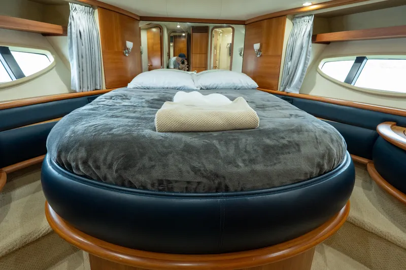 Slide: The Image of Luxurious bedroom interior of 2008 Azimut 62E yacht with plush bedding and elegant wood finishes. - 28