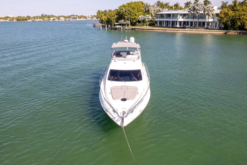 Slide: The Image of 2008 Azimut 62E yacht anchored in serene waters near luxury waterfront homes. - 3