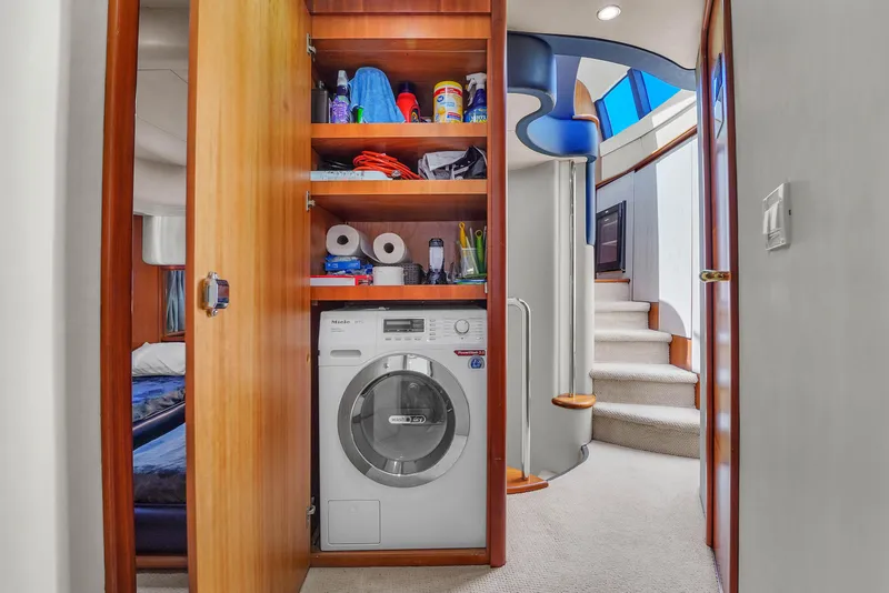 Slide: The Image of Laundry area with storage shelves on a 2008 Azimut 62E yacht interior. - 44