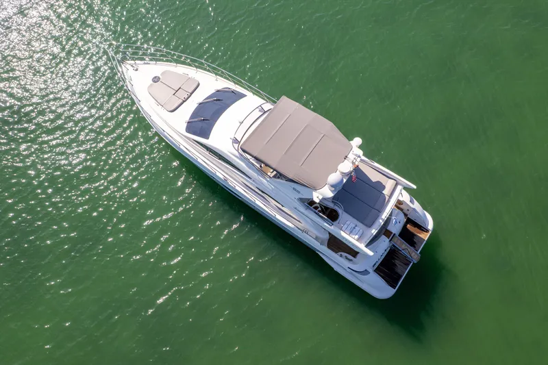 Slide: The Image of Aerial view of 2008 Azimut 62E yacht cruising on green water. - 5