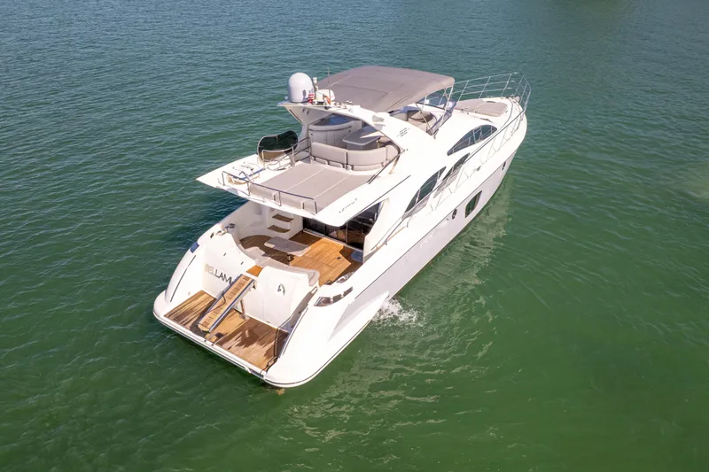 Slide: The Image of 2008 Azimut 62E yacht cruising on calm green waters. - 6