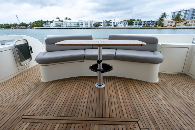 Slide: The Image of Luxury seating area on 2008 Azimut 62E yacht with wooden deck and waterfront view. - 9