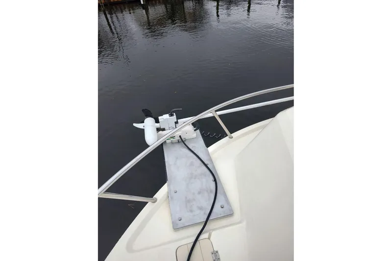 Slide: The Image of Bow of 2004 Parker 2520 XL Sport Cabin with trolling motor on calm water. - 12