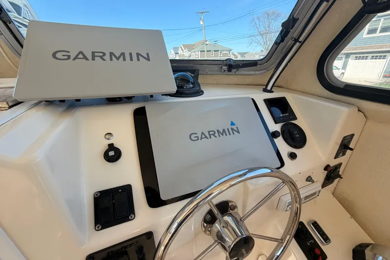 Slide: The Image of 2004 Parker 2520 XL Sport Cabin helm with Garmin navigation system. - 14