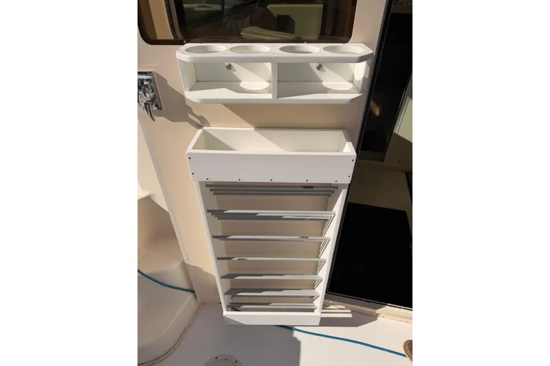 Slide: The Image of Storage compartments on a 2004 Parker 2520 XL Sport Cabin boat interior. - 22