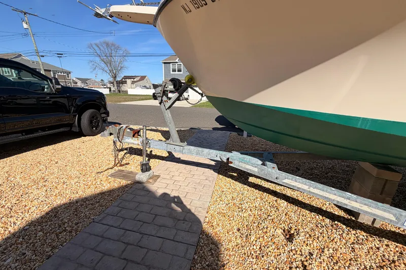 Slide: The Image of 2004 Parker 2520 XL Sport Cabin boat on trailer beside black truck. - 27