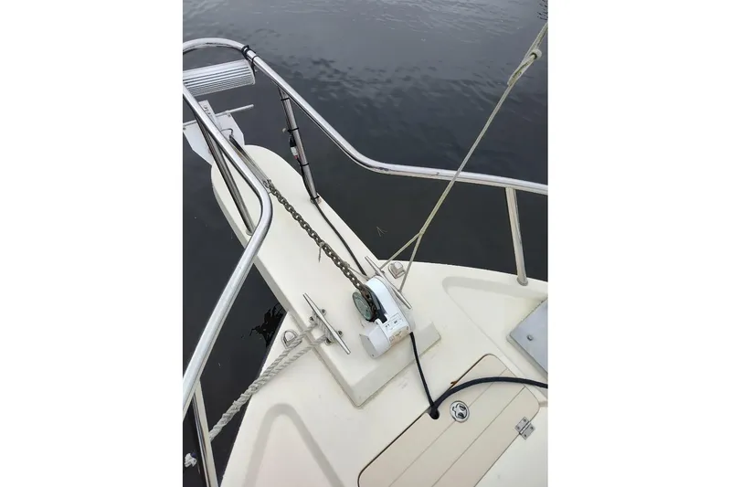 Slide: The Image of Bow of 2004 Parker 2520 XL Sport Cabin boat with anchor and railing. - 4