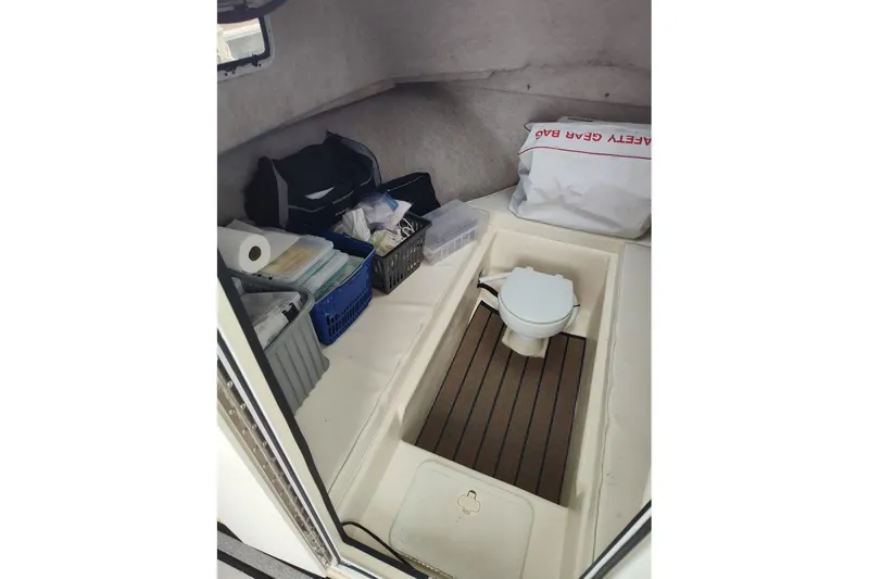 Slide: The Image of Interior of 2004 Parker 2520 XL Sport Cabin with storage and portable toilet. - 7