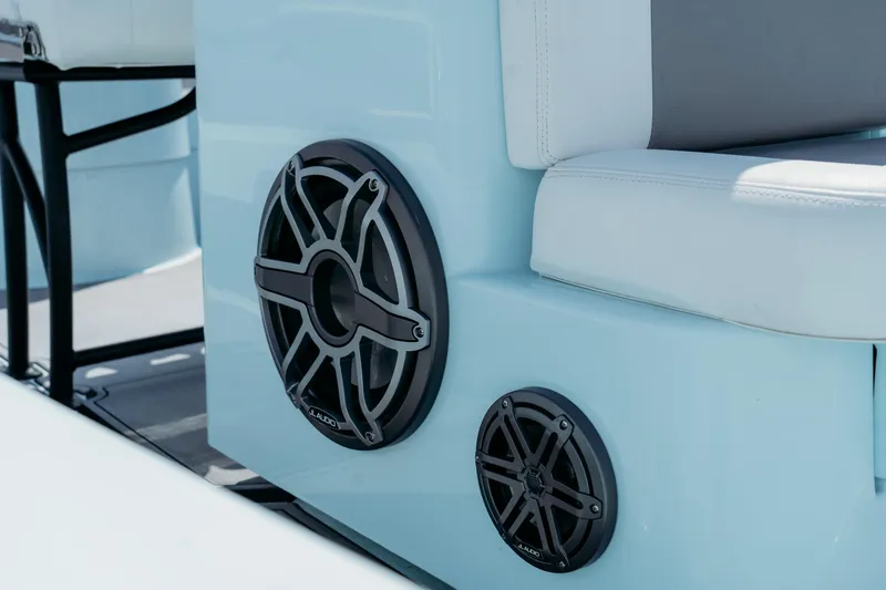 Slide: The Image of 2025 East Cape 25 Hybrid boat with JL Audio speakers and cushioned seating. - 11