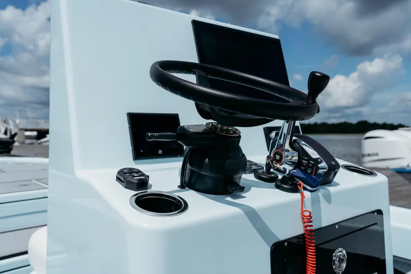 Slide: The Image of 2025 East Cape 25 Hybrid boat console with steering wheel and controls. - 5