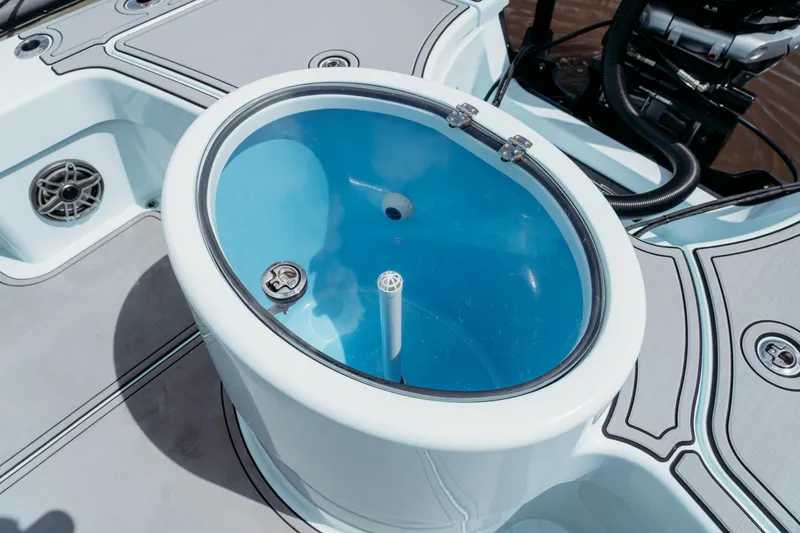 Slide: The Image of 2025 East Cape 25 Hybrid boat with a blue livewell on deck. - 7