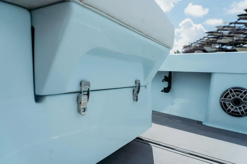 Slide: The Image of 2025 East Cape 25 Hybrid boat interior with storage compartment and speaker. - 9