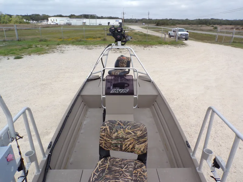 Slide: The Image of 2022 Alweld 1960V boat with camouflage seats on gravel path. - 13