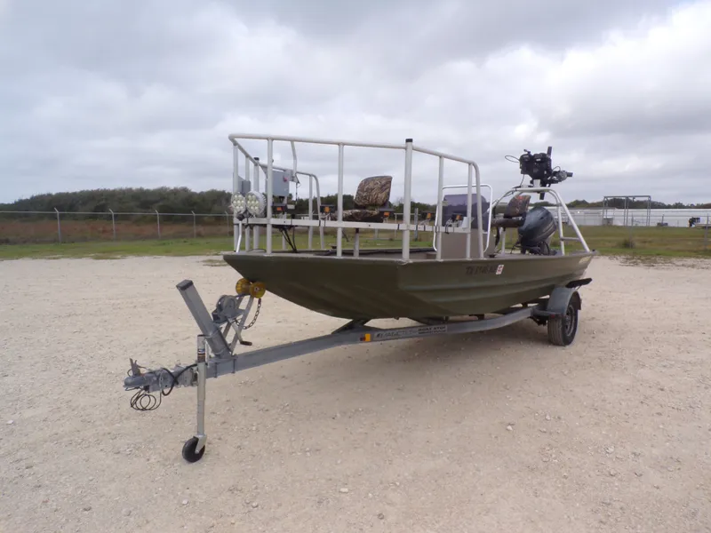Slide: The Image of 2022 Alweld 1960V boat on trailer, parked outdoors. - 6
