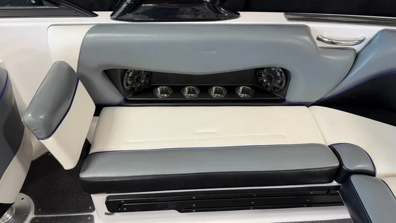 Slide: The Image of The image shows the interior of a 2016 Moomba Mojo boat with gray and white seating. - 25