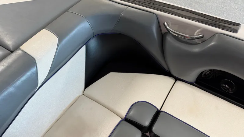 Slide: The Image of Close-up of gray and white upholstery in a boat, featuring a silver handle. - 39