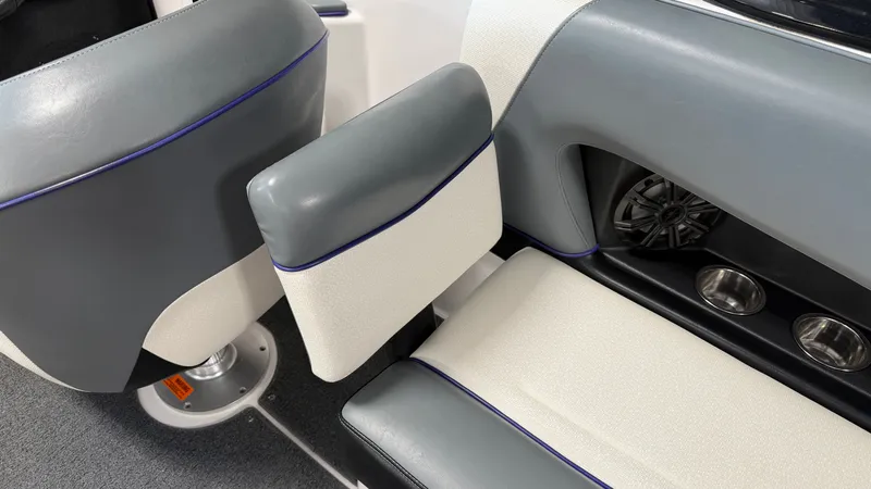 Slide: The Image of Interior of a 2016 Moomba Mojo with gray and white seating and speakers. - 26