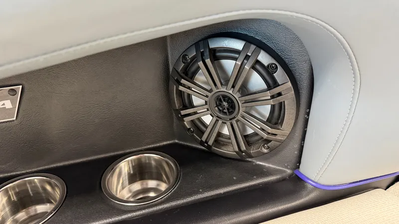 Slide: The Image of Close-up of a speaker and two stainless steel cup holders in a boat. - 30